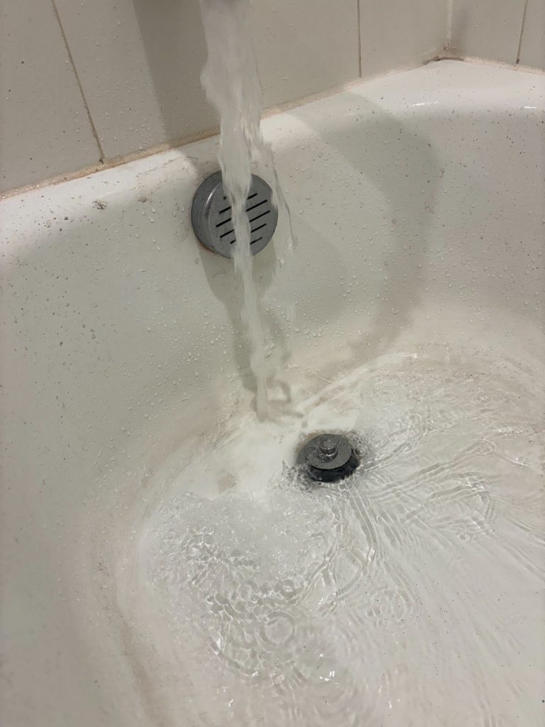 A clogged bathtub drain cleaning