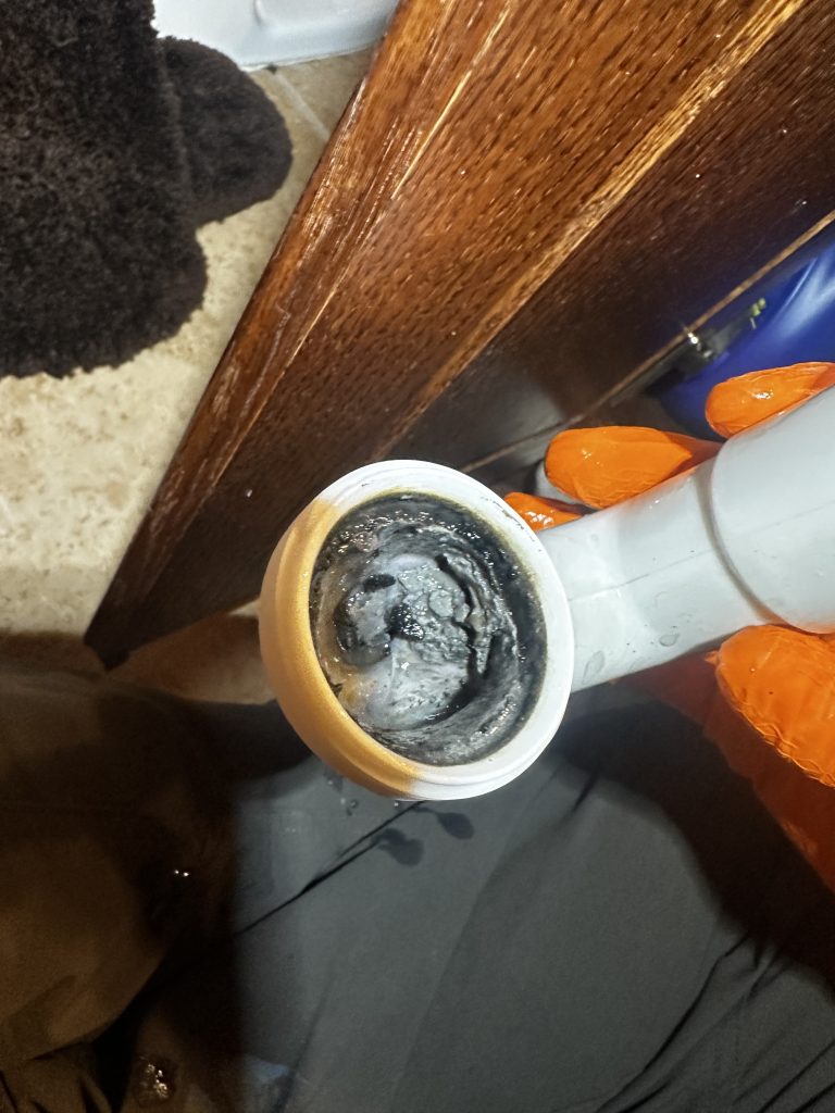 A sink drain being unclogged.